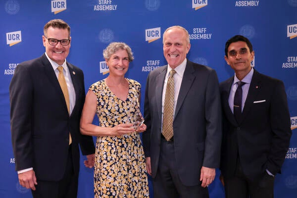 Provost Elizabeth Watkins with Staff Assembly '21-'22 President Jeff Girod, Chancellor Kim Wilcox, and Staff Assembly '22-'23 President Agam Patel at the 2022 Outstanding Staff Awards