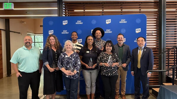 2026 Outstanding Staff Awardees posing with CHRO Alex Najera and Chancellor S. Jack Hu