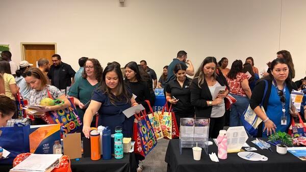Community Partner Fair attendees visiting vendor booths.