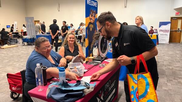 UCR staff chatting with a CPF vendor.
